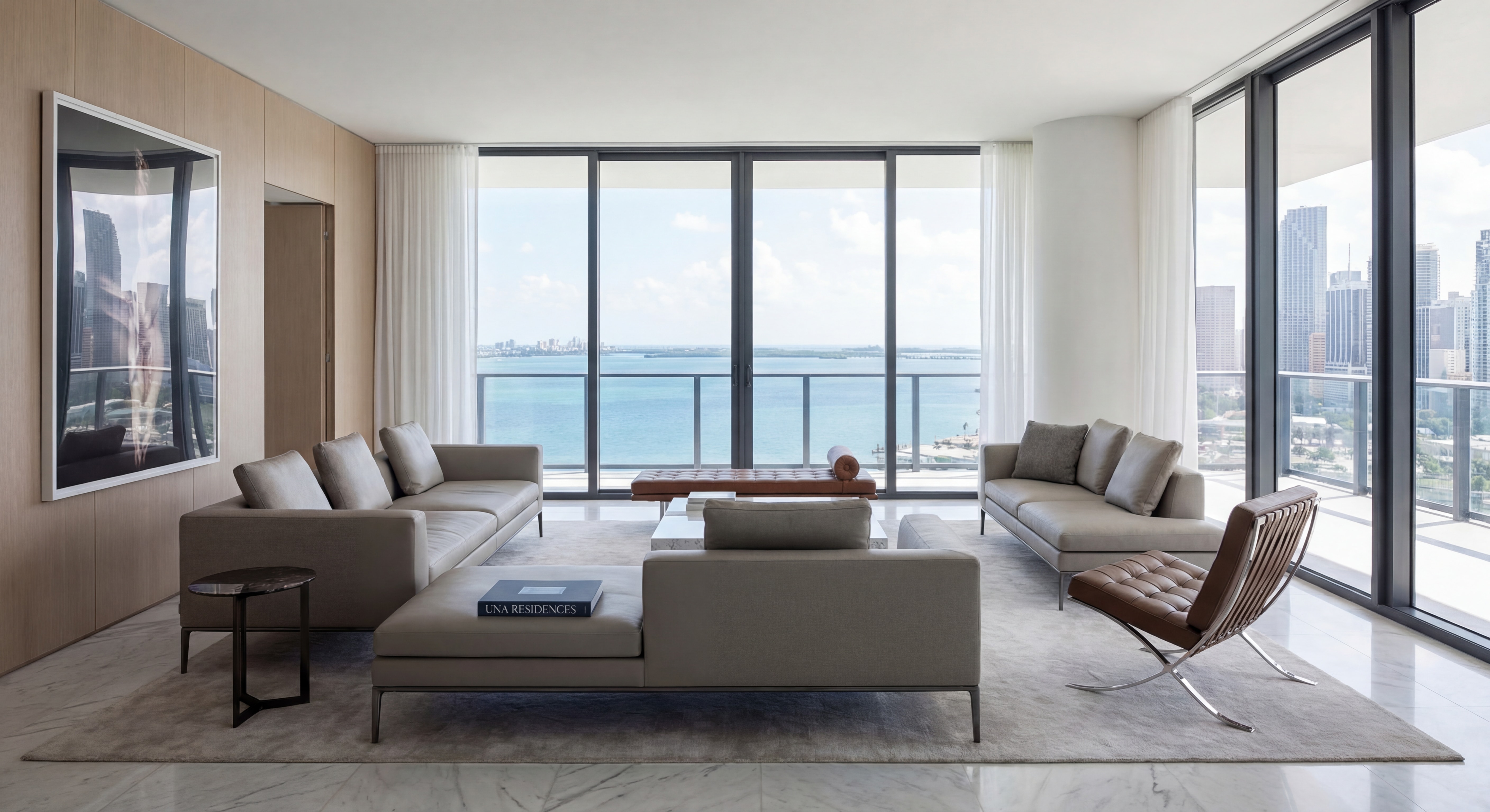 Modern luxury condo interior at Una Residences with floor-to-ceiling windows overlooking Biscayne Bay