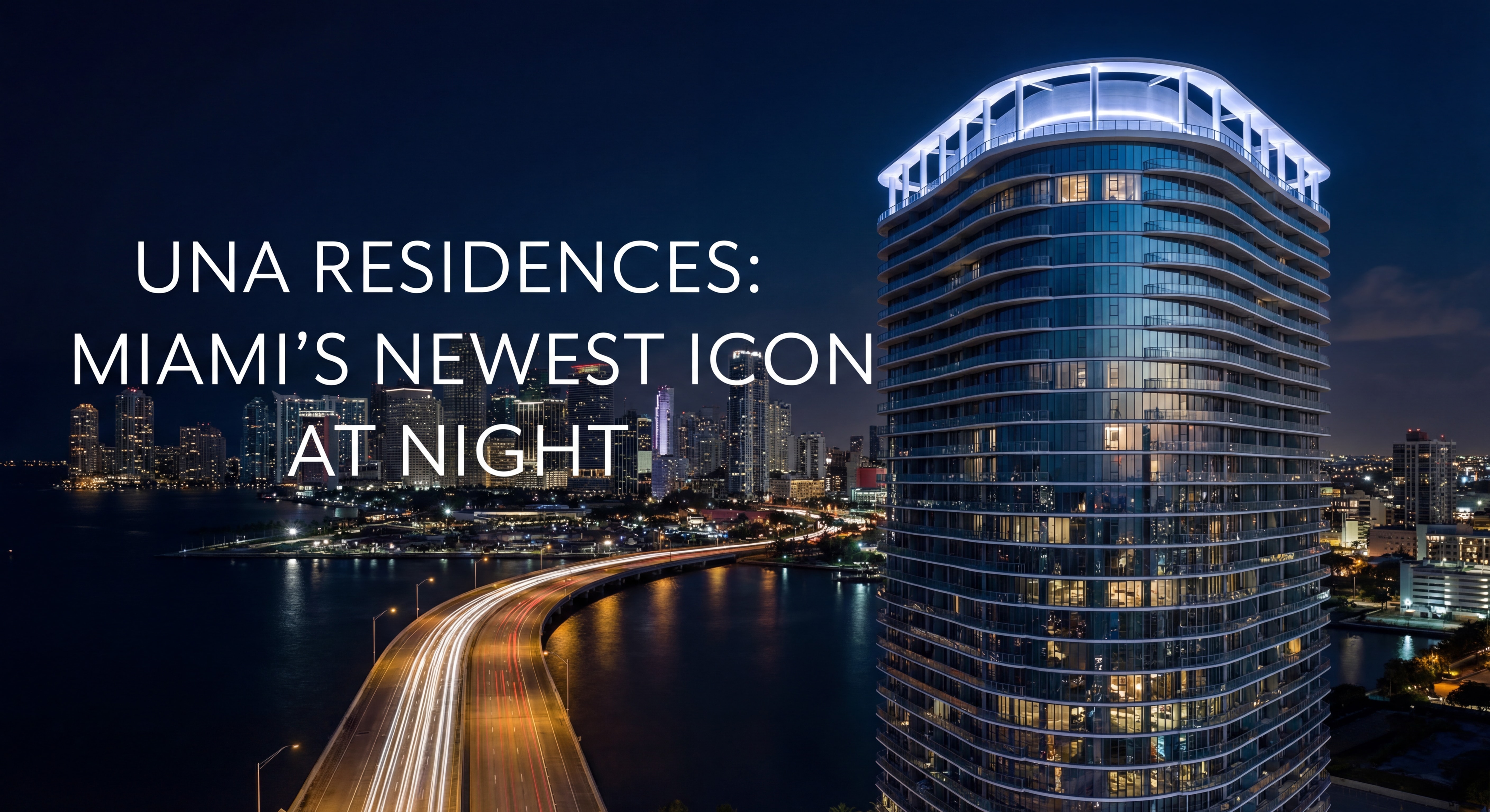 Dramatic nighttime photograph of Una Residences tower illuminated against Miami skyline
