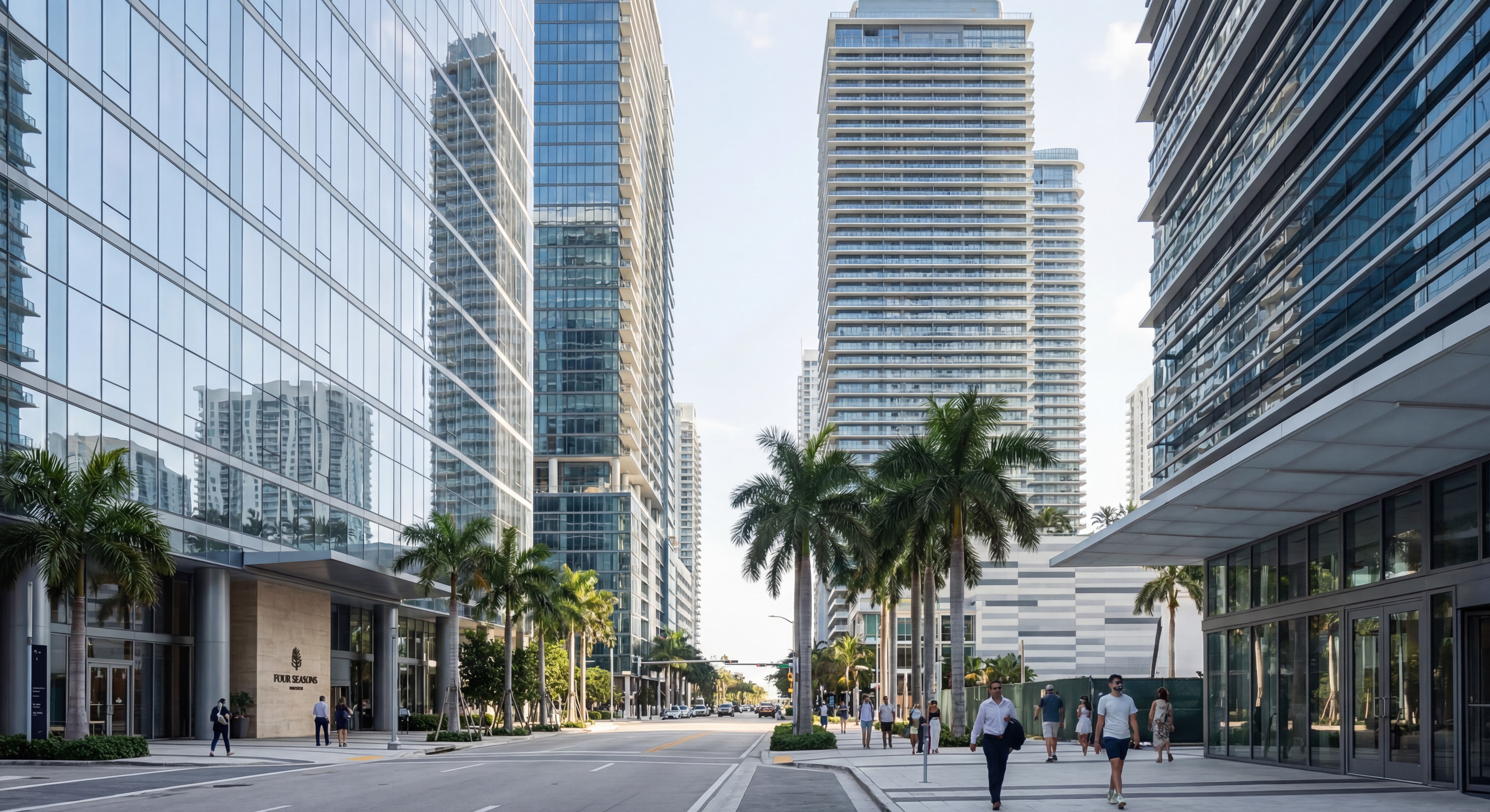 Street-level view of Brickell Avenue luxury condo towers with glass facades reflecting the Miami skyline and Biscayne Bay waterfront