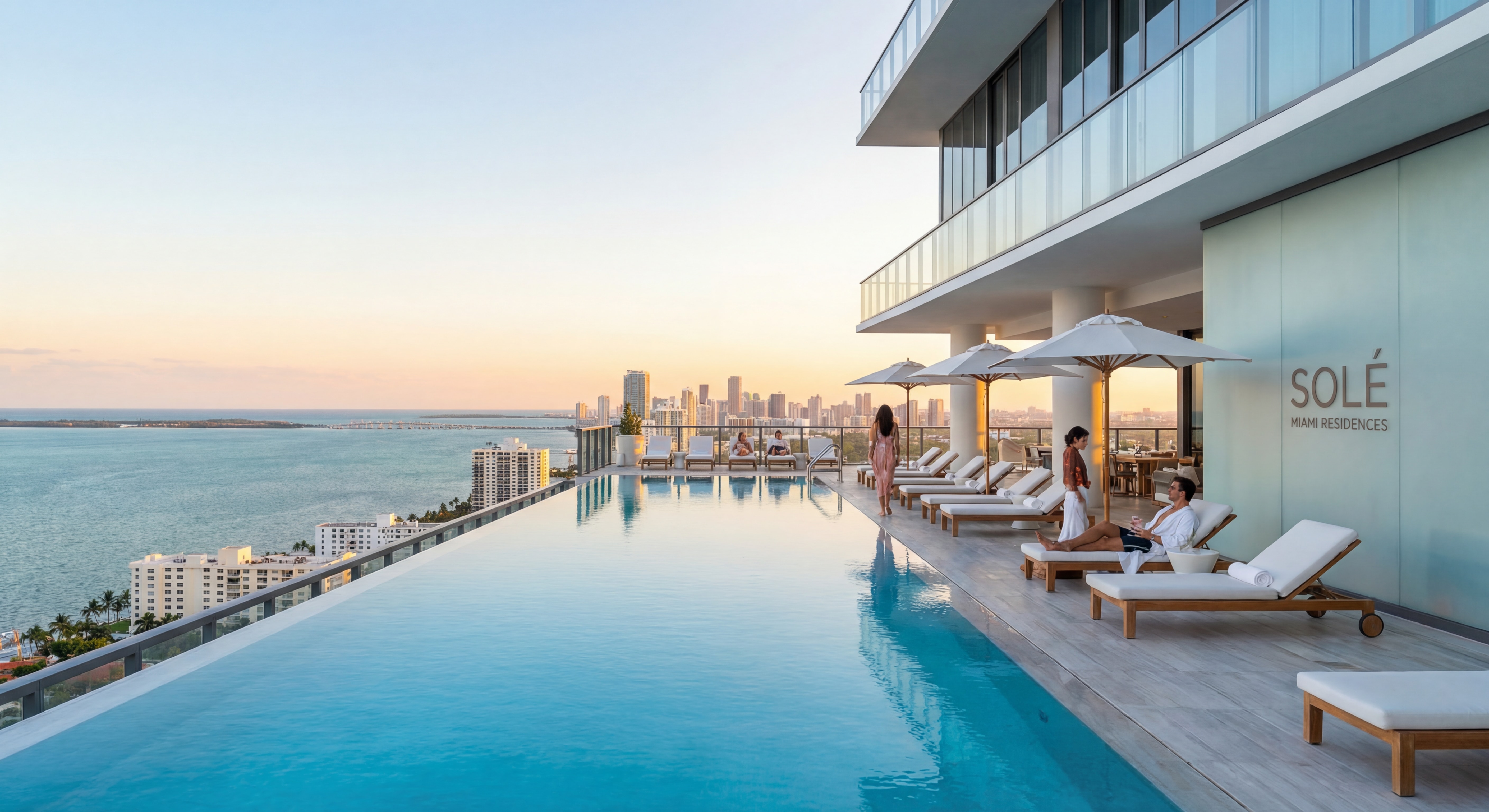 Rooftop infinity pool at a branded luxury Miami condo tower with panoramic views of the ocean and city skyline