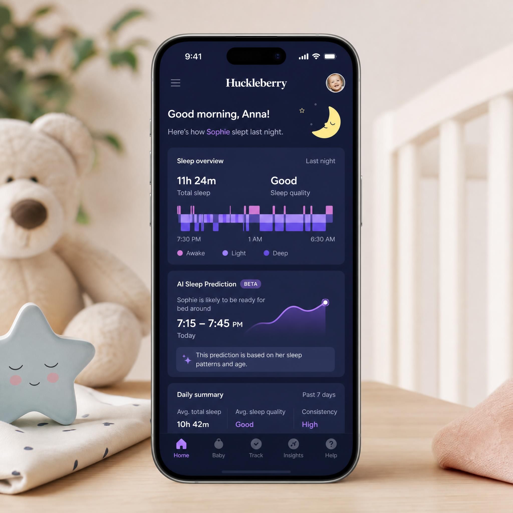 smartphone affichant tableau de bord application Huckleberry suivi sommeil bébé avec graphiques et prédictions IA