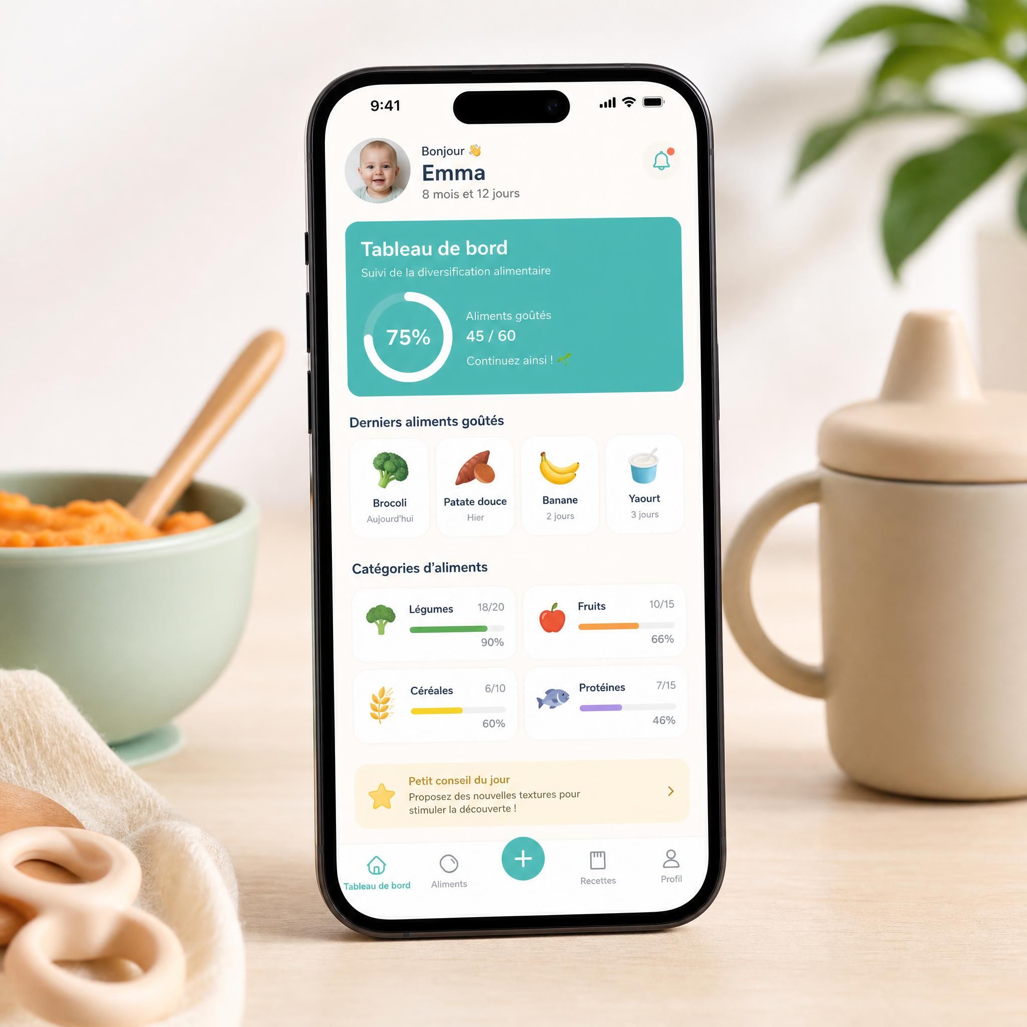 Écran de smartphone affichant une application de suivi de diversification alimentaire pour bébé avec tableau de bord coloré
