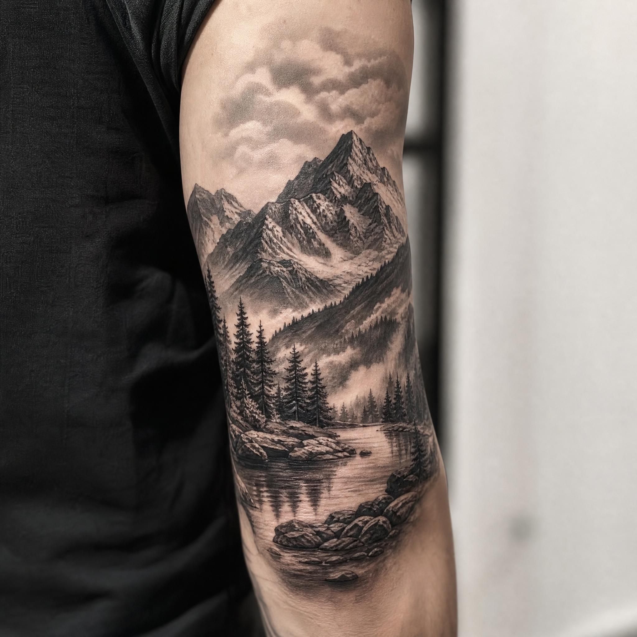 Illustration d'un tatouage réaliste noir et gris représentant un paysage montagnard sur un bras, style illustratif détaillé sans texte