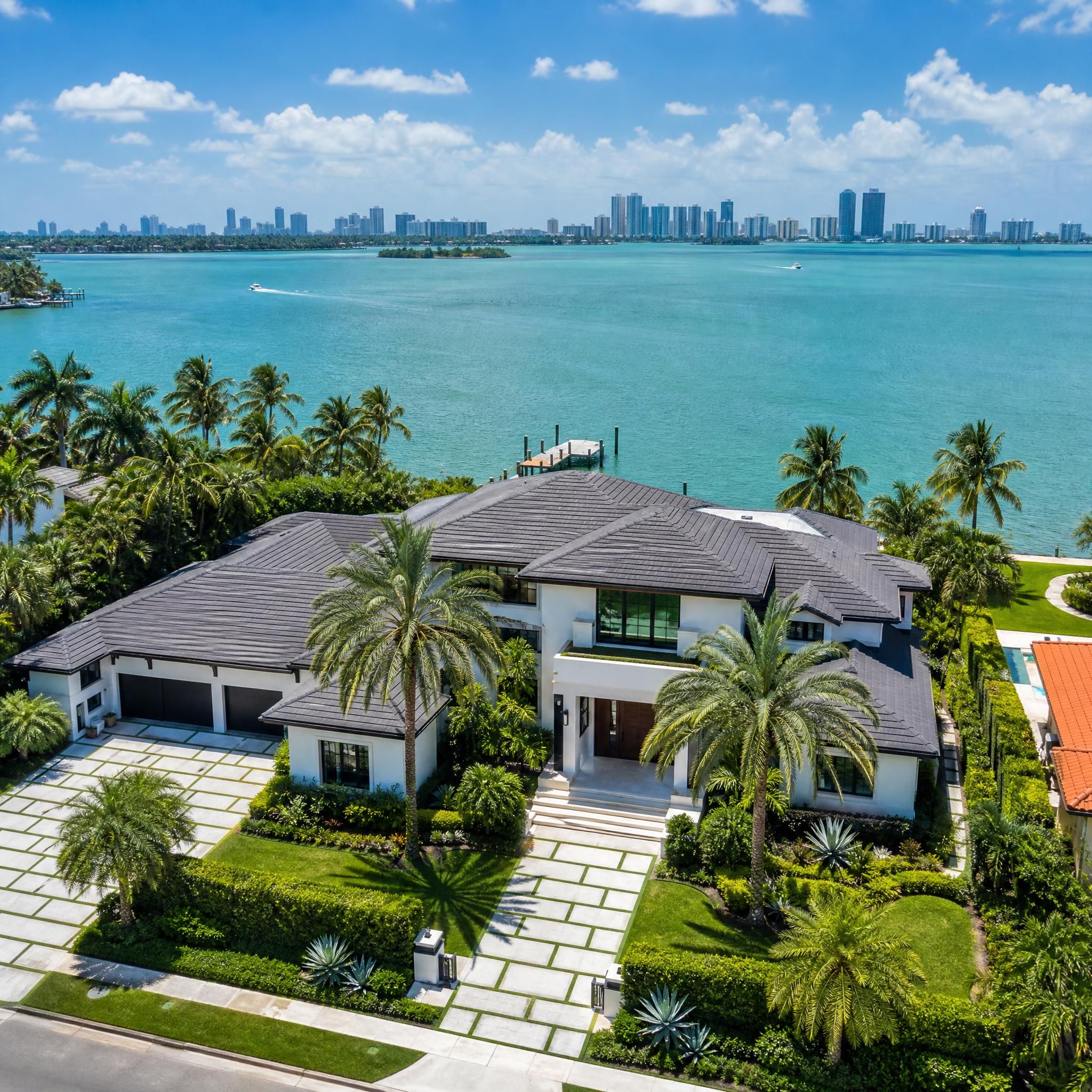 Aerial view of luxury waterfront home in Miami-Dade County with Biscayne Bay in the background, South Florida real estate