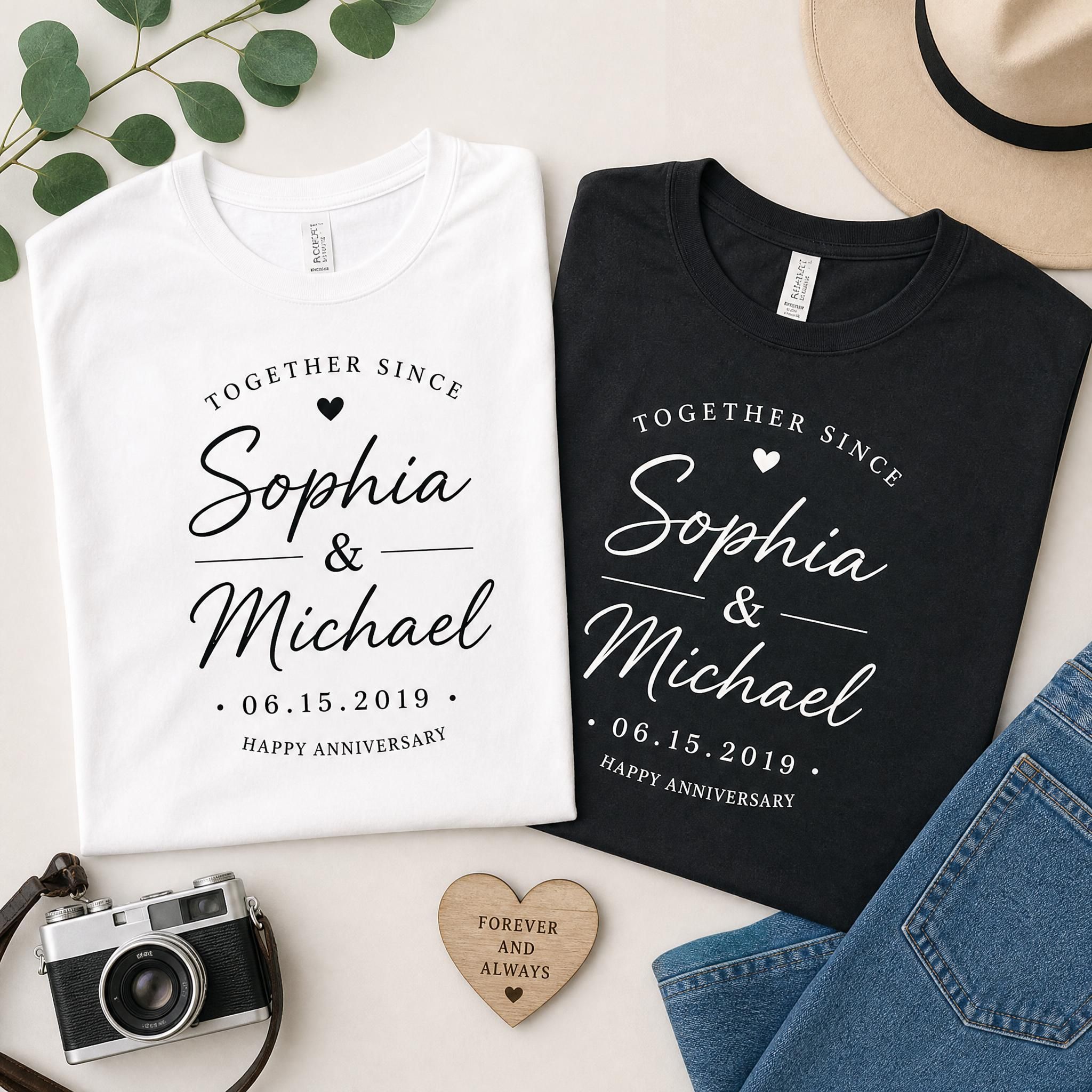 Flat lay of personalized anniversary shirts with custom names and wedding date design