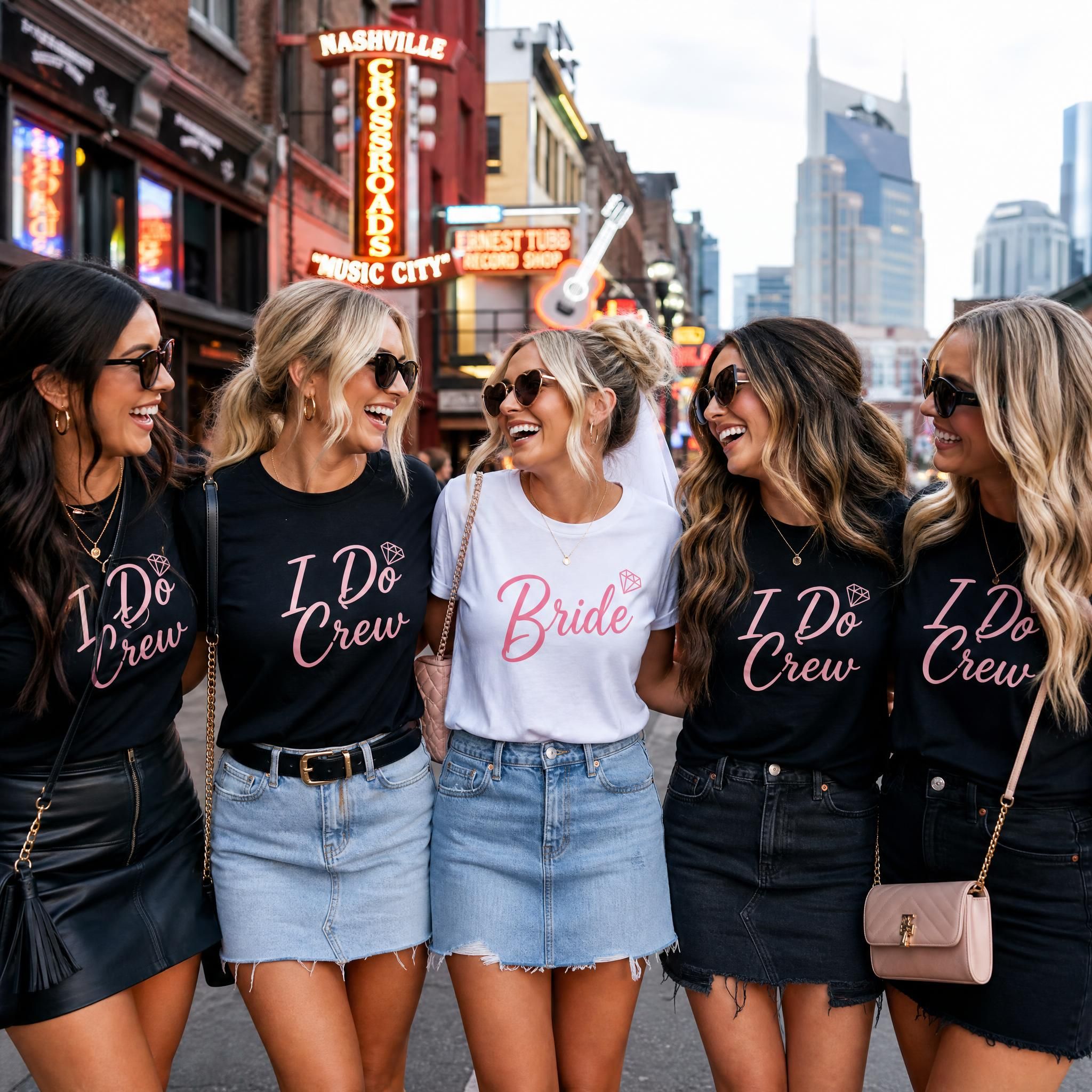 Bride wearing a Bride shirt surrounded by bridesmaids in matching I Do Crew bachelorette tee shirts at a Nashville bar crawl